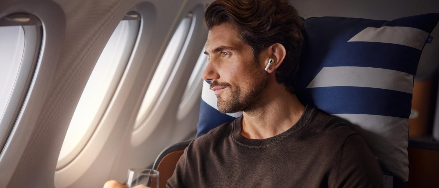 Man on airplane with airpods.