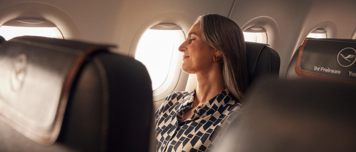 Woman sitting in an airplane.